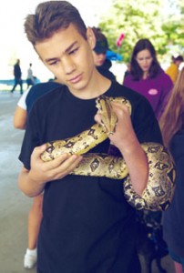 Lief Orrell, 15, hold a redtail boa.