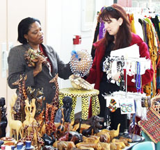 Tina Ojukuwulu, left, shows African art for sale to Tammy Williams Tuesday during Black History Month.