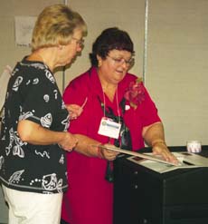 Barbra Burgis helps a voter.