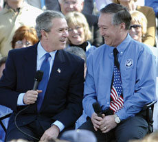 President Bush talks to John Lake, president of Rain for Rent.