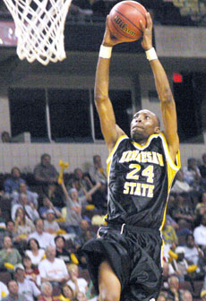 Terrence Hill, a guard from the Kennesaw State Owls, slam dunks the ball in the Final Four semifinal game against Humboldt State.