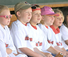 A group of students wait in the dugout before stepping up to bat. This was the ninth year for the field trip.