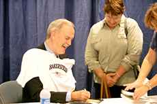 John Cleese, signs a DVD for Phyllis Gutierrez at the Bakersfield Business Conference.