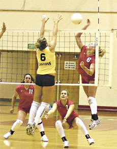 Bakersfield College´s Doneice Woody spikes the ball as College of the Canyons´ Natalie Cole tries to block it.