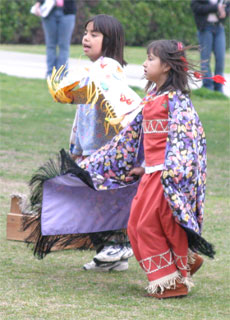 Cousins Xena and Angel Montanez dance to the beat of the drums.