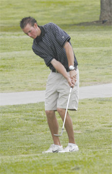 Bakersfield College golfer Brandon Olsson chips the ball on the green.