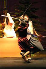 Keith Silvas, who plays Tajomaru, and Vincent Cruz as Takahiro battle as Natasha Spickenreuther (Kinume) tries to get out of the way in the play Rashomon.