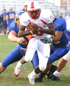 Bakersfield College running back J.R. Rogers attempts to break a tackle from L.A. Harbor´s Jeremy Ehinger, left, and Tory Morgan. Rogers rushed for 203 yards in the game.