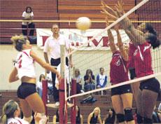Bakersfield Colleges Haylee Varner (on left) spikes the ball to the side of Pierce College.
