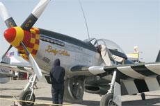 A man hangs out of the Lady Alice, an aircraft on display at the Minter Field Air Show on April 19.