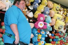 Russ Markusson, a carnie operates his balloo popping exhibit at the Kern County Fair.