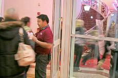 People run into the building as Larry Evans takes tickets at Edwards Cinema during the midnight showing of Twilight.