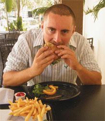 Manuel Morfin munches on a veggie burger.