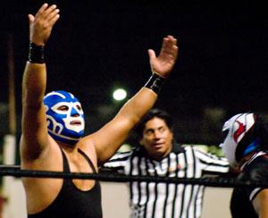 Huracan Ramirez Jr. and referee El Guapo stand in the ring during the Lucha Libre wrestling event at the Kern County Fair Grandstand on Sept. 27.