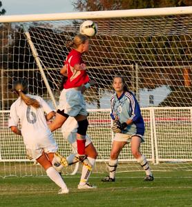 Bakersfield College forward Terryn Soelberg attempts to head a corner kick past Cougars goalie Carolina Dozal during the second half of a game at Bakersfield College on Nov. 13. BC won the game 2-1 ensuring the team a chance in the playoffs.
