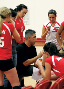 Bakersfield College volleyball head coach Carl Ferreira talks with teammates during a timeout against Glendale in the BC gym Nov. 19.