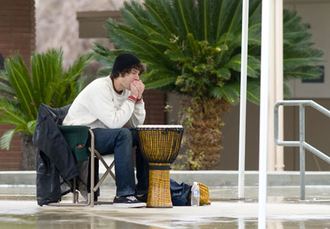 Bakersfield College history major Austin Wooldridge warms his hands during a break from playing an African djembe drum under the Campus Center gazebo Jan. 19.