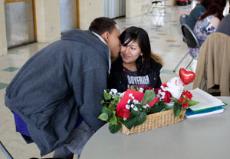 Jason Ramirez and Katrina Salutan share a Valentines Day kiss in the Bakersfield College cafeteria Feb. 14