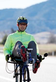 BC professor Scott Wayland rides his recumbent bicycle down Red Apple Road in Tehachipi, Calif. on Feb. 12.