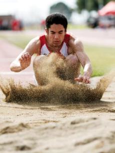 Dominique Cervantes lands in the pit as he competes in the mens long jump at the Bakersfield College Triangular Meet at BC on Feb. 19.