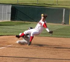 Cerritos Colleges Courtney Priddie slides into third base, and Bakersfield College pitcher Annissa Carendar in the second game of a double-header at BC on April 1.
