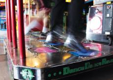 Patrons practice DDR moves at 3D Arcade on April 11.