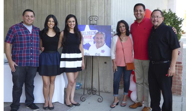 Widow Rachel Gonzales poses with her children around a photo of Manuel Gonzales Jr. at the scholarship fundraiser event. Manuel passed away earlier this year and was a counselor at Bakersfield College for 37 years.