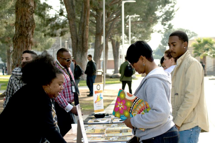 Grant Johnson and his mother, Alisa Johnson, asking Michell Williams for information on Lincoln University.