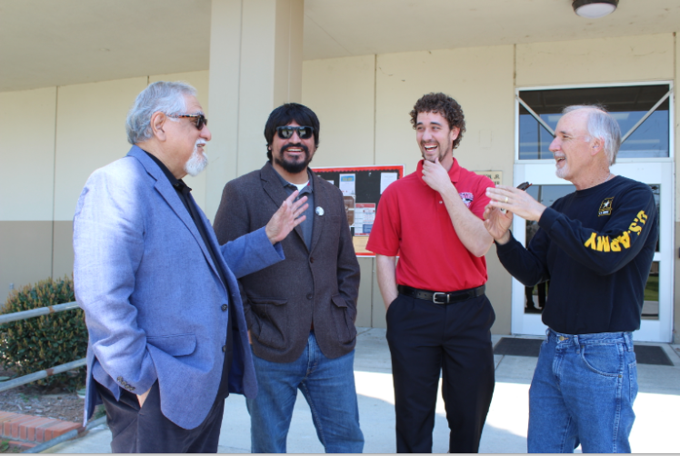 Former BC history professor David Rosales and former BC counselor Steve Schultz recount old stories as their sons listen intently.