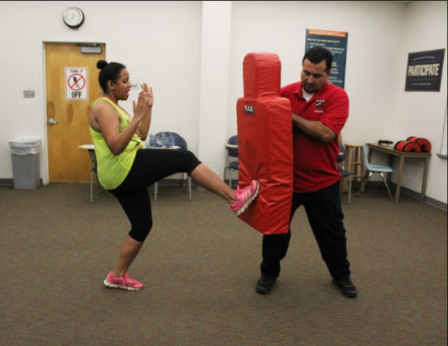 Ambria King practices her Rape Aggression Defense blocks and kicks on foam pads. Training took place over two days, with day one as an educational day covering defensive practices, and day two focusing on physical training and defensive moves.