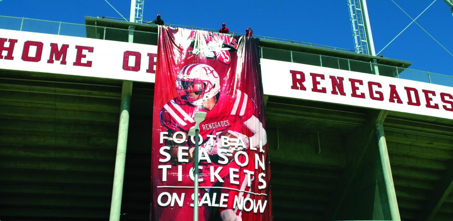 A banner announcing the start of season ticket sales unfurls as the crowd watches on.