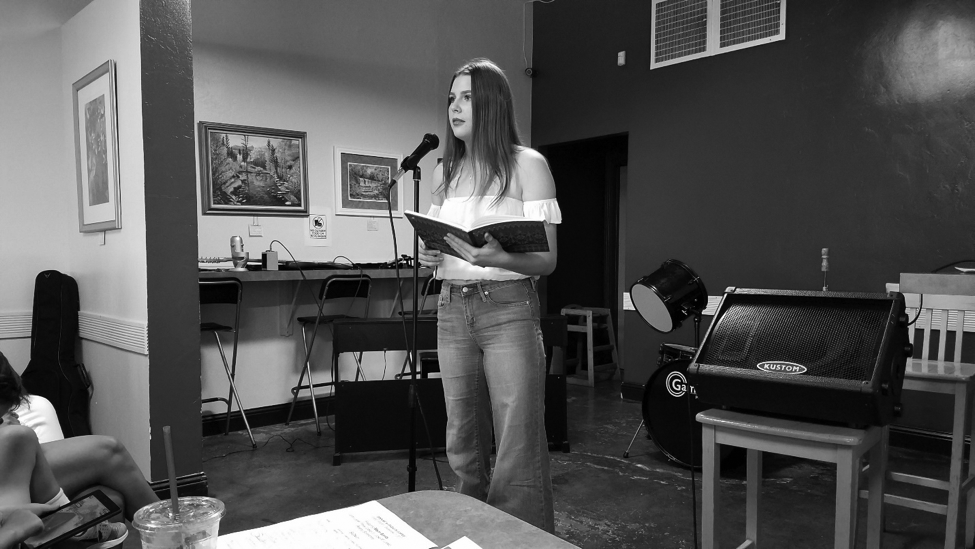 Emily Andrew recites poetry about heartbreak and women’s empowerment at Dagny’s Coffee Company.