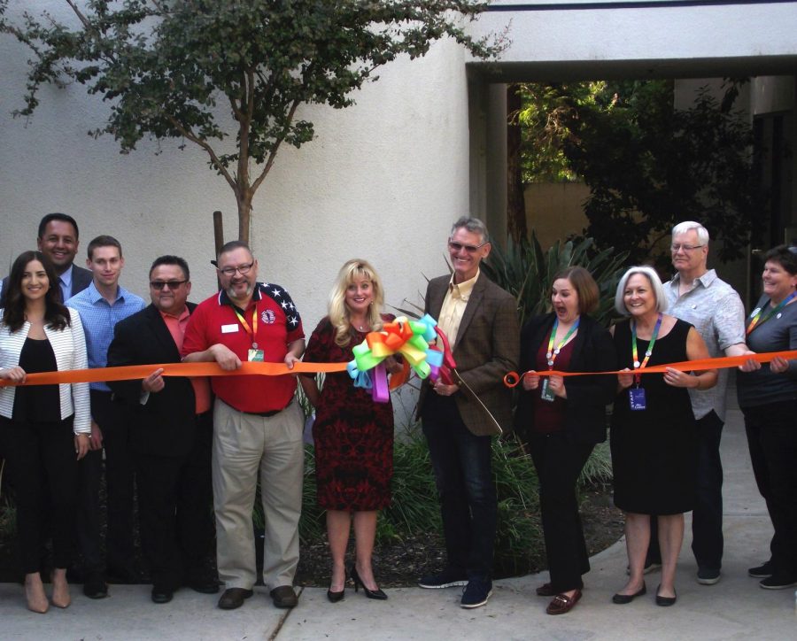 Guests pose and smile as Vice Mayor and Ward 4 councilman Bob Smith cuts the ribbon
for the opening of the newAnnex of the Gay and Lesbian Center in Bakersfield.