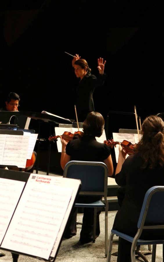 Kathryn Kuby, the Bakersfield College concert band and orchestra conductor, as she conducts the BC orchestra at the Sound of Autumn fall concert.