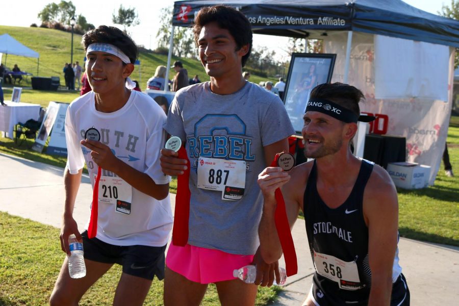 Sebastian Garcia, Mark Gulesian and Ryan Lucker show off their medals after participating in the MADD Dash event.