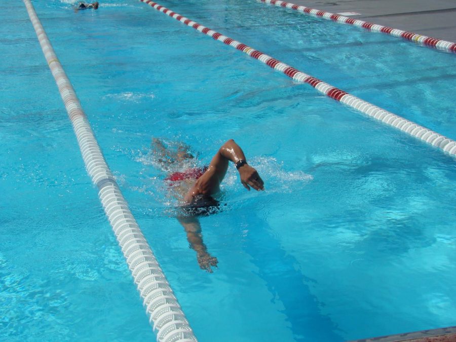 Mark Moon, the head coach of the men’s and women’s Bakersfield College swim teams, shows off his technique during the swimming relay.