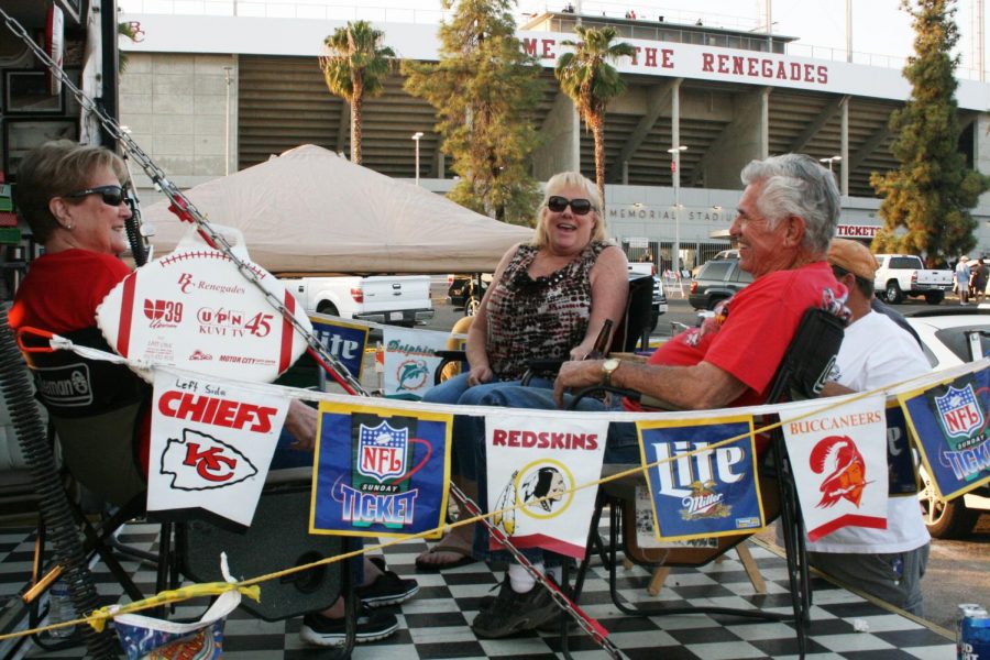 From the left: Barbar Lopez, 79, Karen Tallman, 57, James
Tallman, 55, and Buddy Lopez, 83 throw their own tailgate
party at the homecoming game.