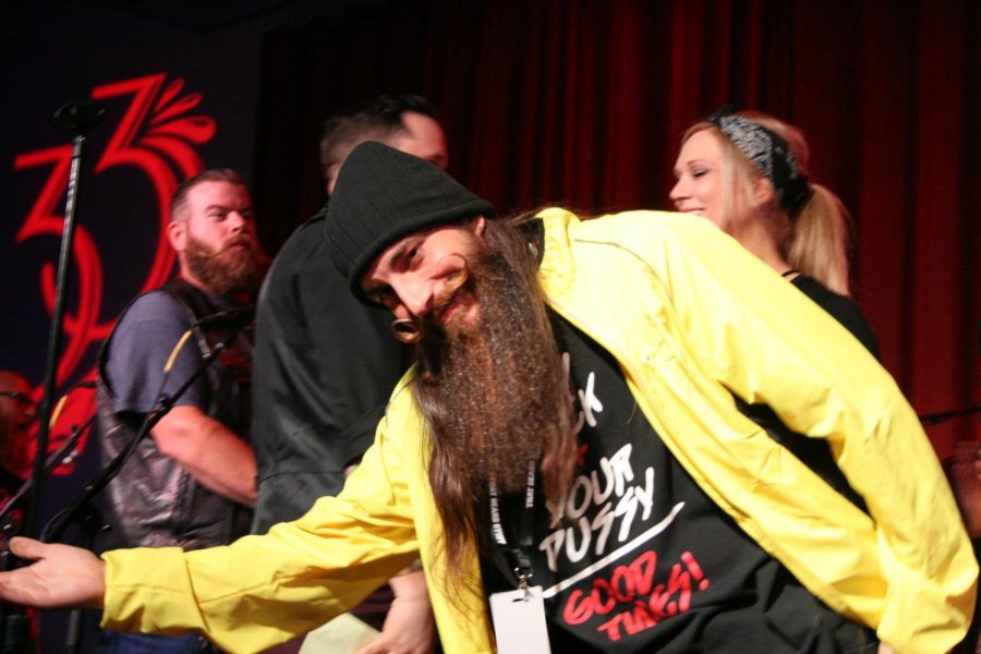 Male contestant for Natural Beard (over 12 inches) category presents his beard to judges.