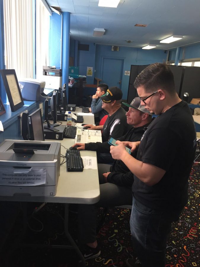 Veteran students use the computer in the veteran lounge to register for classes and do their homework