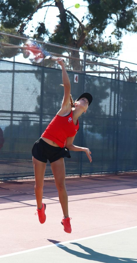 BC Tennis player Paige Darstein serving during her singles match against 
Fresno City College