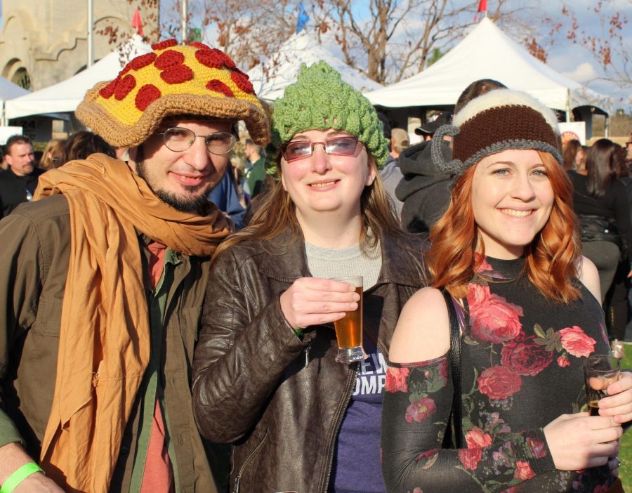 Thomas Powell, Denise Powell, and Shanon Sutton are in the spirit of Pizza and Beer Fest with their unique hats