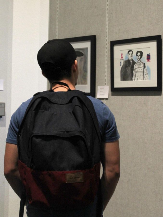 Inside the Wylie and Mary Louise Jones Gallery at Bakersfield College, BC student Joseph Lara examines the artwork on display. 