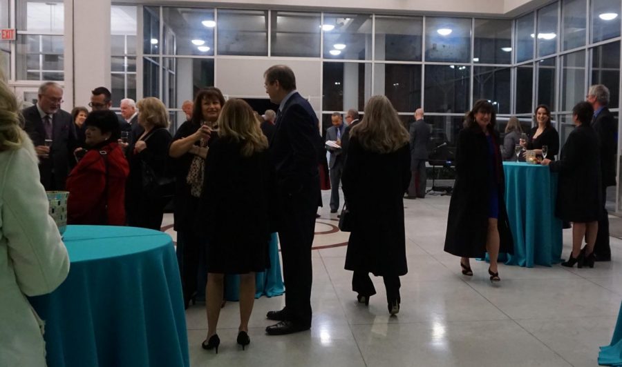 Guest enjoy the reception with hors d’oeuvres at the library.