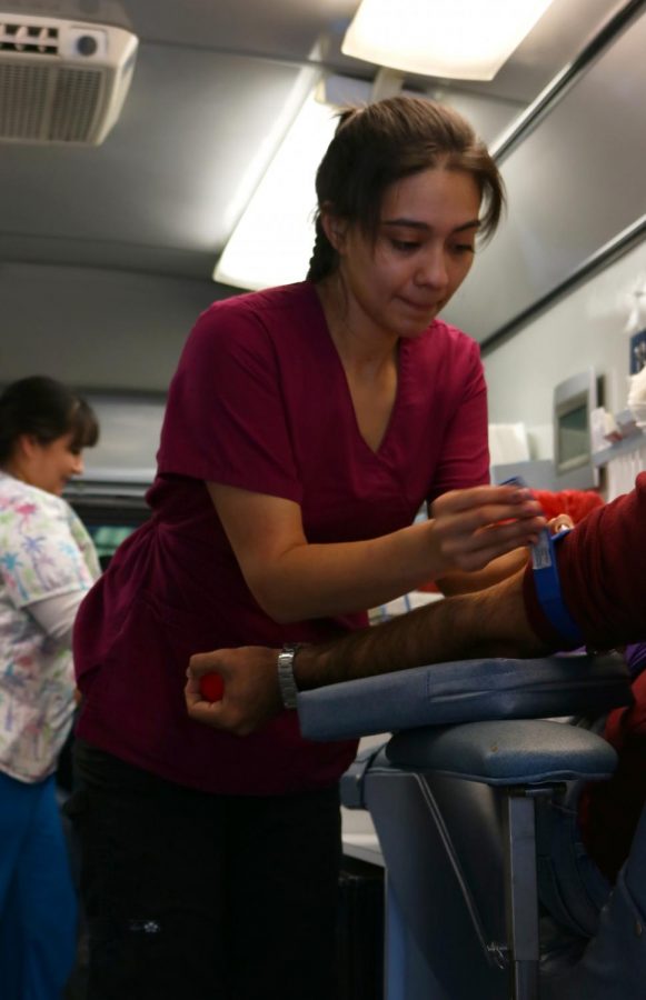Phlebotomist Angie Johnson in one of the Houchin mobile blood banks as she preps a BC student before drawing blood, she was one of many medical professionals at the Annual BC Blood Drive at Bakersfield College. 