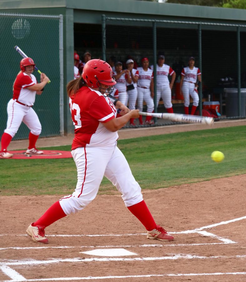 McKenna Valencia of Bakersfield College hitting the softball and running to first base at the home game against Santa Monica College. 