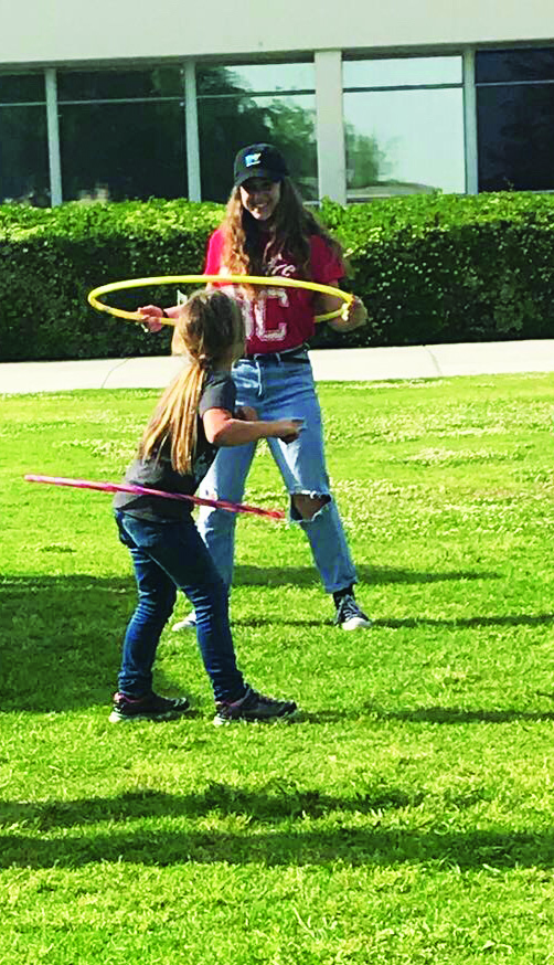 BC Student Life employee Ashly Harp, enjoys some hula-hoops with little girl.  