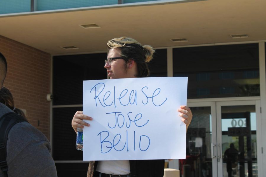 Protester, Chase Wren, holds a sign that says Release Jose Bello