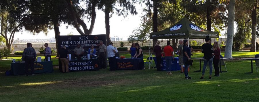 Host talk to attendees and amongst themselves during the Job Fair at the Sheriff’s Headquarters.