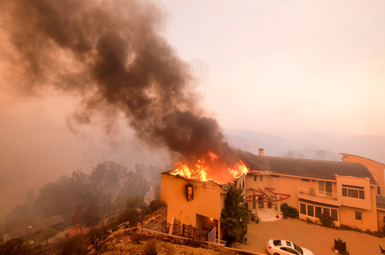 A house in Malibu, Calif. burns downs as wildfires spread throughout southern and northern California in November. 