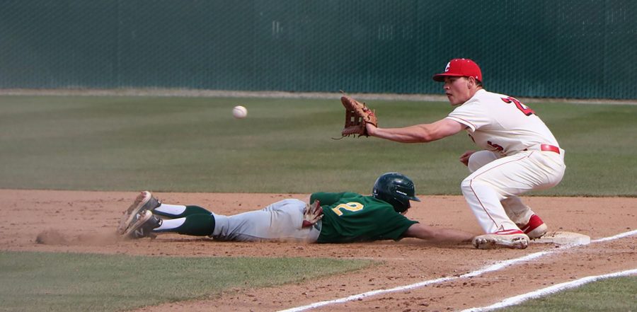 First baseman Trey Harmon trying to get the runner out on first.  